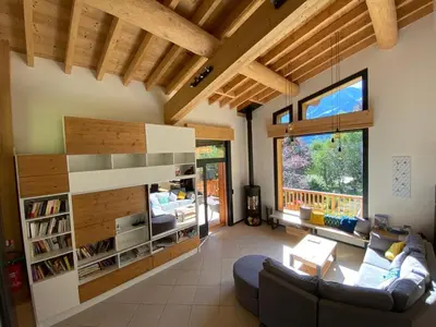 a living room with a couch and a table at Chambres d'hôtes - B&B - Chalet Mountain Vibes in Les Houches