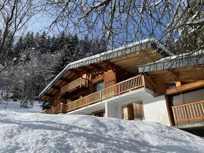 a log cabin with snow in front of it at Chambres d'hôtes - B&B - Chalet Mountain Vibes in Les Houches