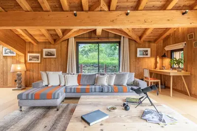 a living room with a couch and a table at DIFY Chalet Contemporain - Les Praz de Chamonix in Chamonix-Mont-Blanc