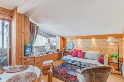 a living room with a couch and a table at Appartement Megève - Welkeys in Megève