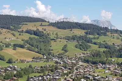 a village in a valley with mountains in the background at Appartement Megève - Welkeys in Megève