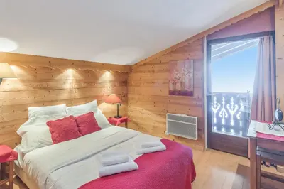 a bedroom with a large bed and a window at Appartement Megève - Welkeys in Megève