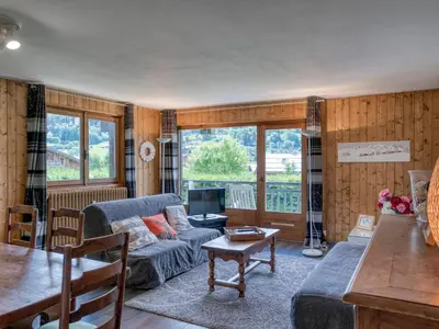 a living room with a couch and a table at Appart 3 pièces proche télécabine - 5 pers - Wifi - Parking - FR-1-453-229 in Megève