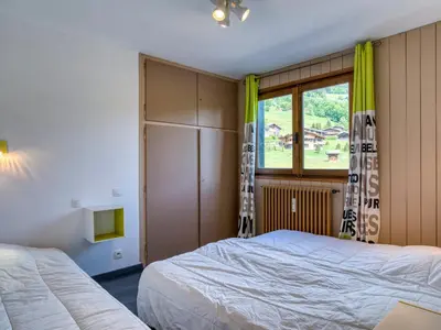 a bedroom with two beds and a window at Appart 3 pièces proche télécabine - 5 pers - Wifi - Parking - FR-1-453-229 in Megève