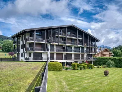 a large building with a large lawn in front of it at Appart 3 pièces proche télécabine - 5 pers - Wifi - Parking - FR-1-453-229 in Megève