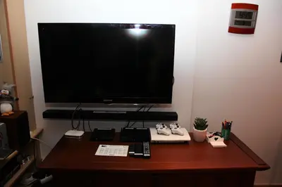 a desk with a large television on a wall at ALPINSTAR in Chamonix-Mont-Blanc