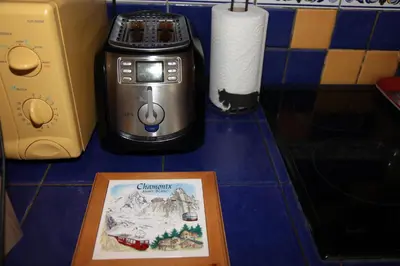 a table with a picture of a camera next to a toaster at ALPINSTAR in Chamonix-Mont-Blanc