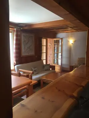 a living room with a couch and wooden tables at L'Atelier in Les Contamines-Montjoie