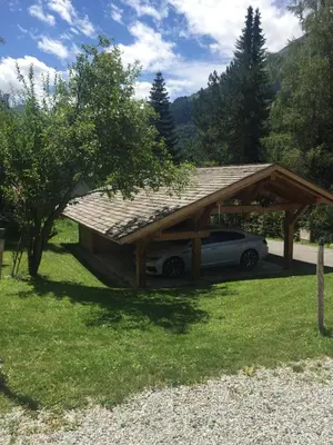 a car under a pavilion with a car under it at L'Atelier in Les Contamines-Montjoie