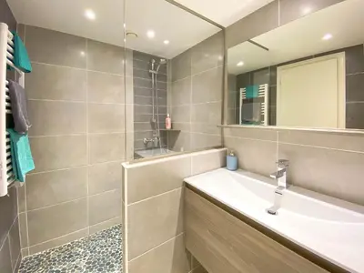 a bathroom with a sink and a mirror at Résidence Mummery Chamonix in Chamonix-Mont-Blanc