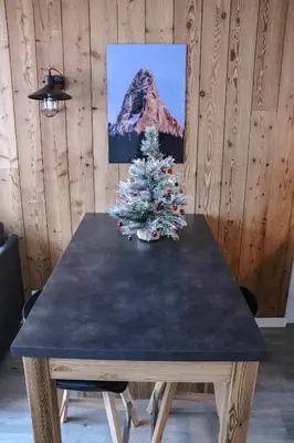 a table with a christmas tree on top of it at Résidence Mummery Chamonix in Chamonix-Mont-Blanc