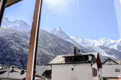 a view of a mountain range from a window at Résidence Mummery Chamonix in Chamonix-Mont-Blanc