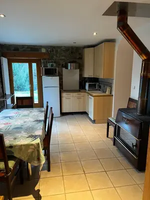a kitchen and dining room with a table and a stove at Appartement Chalet Nerboux in Morillon