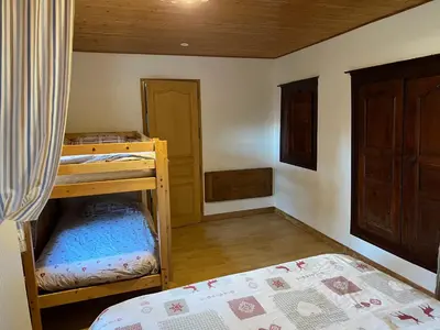 a bedroom with two bunk beds and a bed at Appartement Chalet Nerboux in Morillon