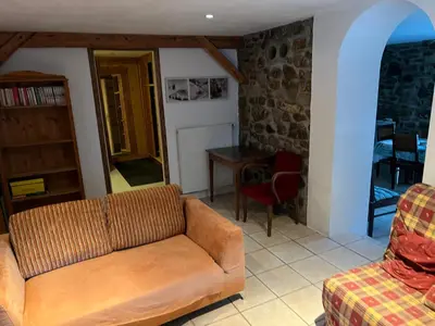 a living room with a couch and a table at Appartement Chalet Nerboux in Morillon