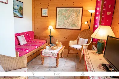 a living room with a couch and a table at Sur Le Feug Appt 14 in Combloux