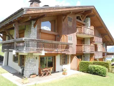 a large house with a balcony on the side of it at Sur Le Feug Appt 14 in Combloux