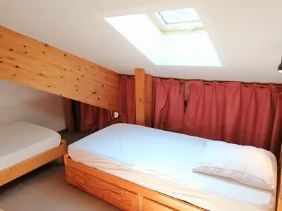 a dining room with a table and a couch at Duplex 4 pièces pour 8 personnes au pied des pistes à Morillon - FR-1-815-76 in Morillon