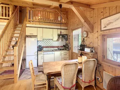 a kitchen with a table and chairs in a cabin at Appartement cosy avec mezzanine, au pied des pistes à Combloux, parking inclus - FR-1-560-25 in Combloux