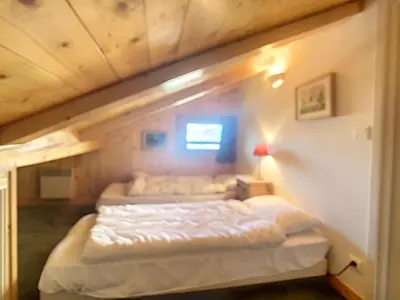 a bedroom with two beds in a room at Appartement cosy avec mezzanine, au pied des pistes à Combloux, parking inclus - FR-1-560-25 in Combloux