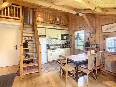 a kitchen with a table and chairs in a cabin at Appartement cosy avec mezzanine, au pied des pistes à Combloux, parking inclus - FR-1-560-25 in Combloux