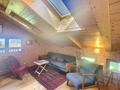 a living room with a couch and a table and chairs at Appartement cosy avec mezzanine, au pied des pistes à Combloux, parking inclus - FR-1-560-25 in Combloux