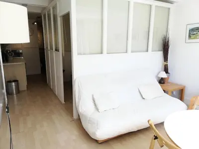 a white couch in a living room with a table at Residence Cassiopee - maeva Home in Flaine