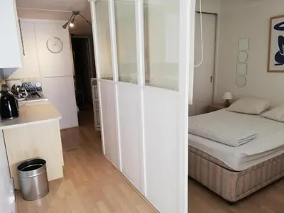 a small room with a bed and a kitchen at Residence Cassiopee - maeva Home in Flaine