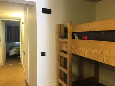 a bedroom with a bunk bed with a ladder at Residence Cassiopee - maeva Home in Flaine