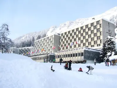 a group of people in the snow in front of a hotel at Residence Cassiopee - maeva Home in Flaine