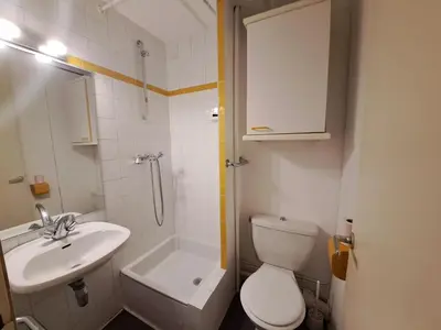 a bathroom with a sink and a toilet and a shower at Residence Cassiopee - maeva Home in Flaine