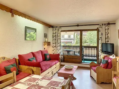 a living room with red couches and a balcony at Charmant 2 pièces au centre de Combloux avec balcon - FR-1-560-2 in Combloux