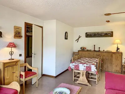 a living room with a bed and a table at Charmant 2 pièces au centre de Combloux avec balcon - FR-1-560-2 in Combloux