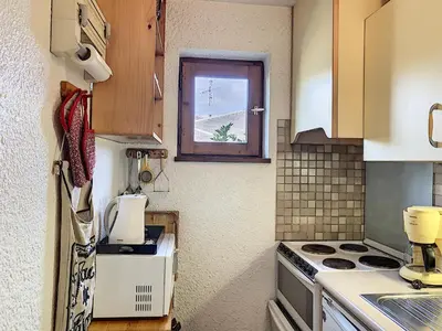a small kitchen with a stove and a window at Charmant 2 pièces au centre de Combloux avec balcon - FR-1-560-2 in Combloux