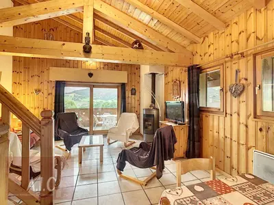 a living room with wood paneled walls and a tv at Grand Duplex 110m² 3 Chambres avec Balcon & Terrasse - FR-1-560-3 in Combloux