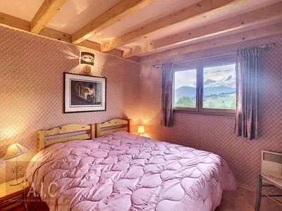 a bedroom with a large bed and a window at Grand Duplex 110m² 3 Chambres avec Balcon & Terrasse - FR-1-560-3 in Combloux