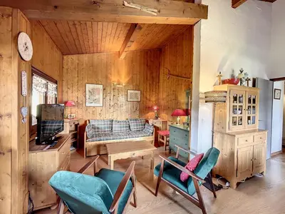 a living room with a couch and a table and chairs at Appartement cosy à Combloux avec parking et cheminée - FR-1-560-9 in Combloux