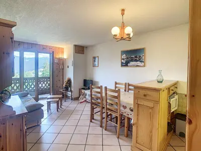 a kitchen and dining room with a table and chairs at 3 pièces standing proche centre - Balcon Expo Est - FR-1-560-5 in Combloux