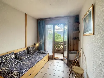 a bedroom with a bed and a view of a balcony at 3 pièces standing proche centre - Balcon Expo Est - FR-1-560-5 in Combloux