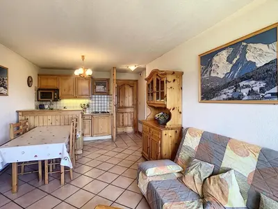 a living room with a couch and a table at 3 pièces standing proche centre - Balcon Expo Est - FR-1-560-5 in Combloux