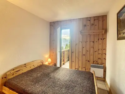 a bedroom with a bed and a window at 3 pièces standing proche centre - Balcon Expo Est - FR-1-560-5 in Combloux