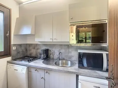 a kitchen with a sink and a microwave at Appartement cosy 3 pièces avec cheminée et parking couvert au pied des pistes à Combloux - FR-1-560-18 in Combloux