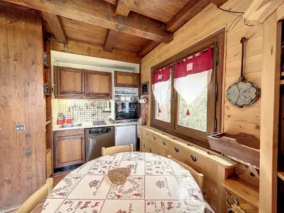 a small kitchen with a table in a room at Charmant duplex près du téléski du Bouchet, idéal pour famille - FR-1-560-11 in Combloux