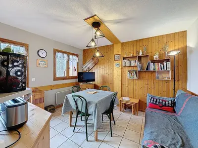 a living room with a table and a couch at Appartement cosy 2 pièces à 2 pas des remontées mécaniques de Combloux - FR-1-560-20 in Combloux