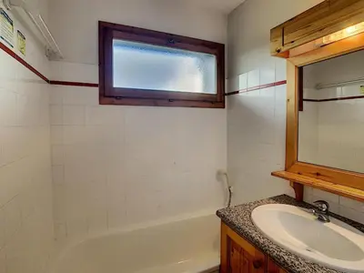 a bathroom with a sink and a tub and a window at Appartement cosy 2 pièces à 2 pas des remontées mécaniques de Combloux - FR-1-560-20 in Combloux