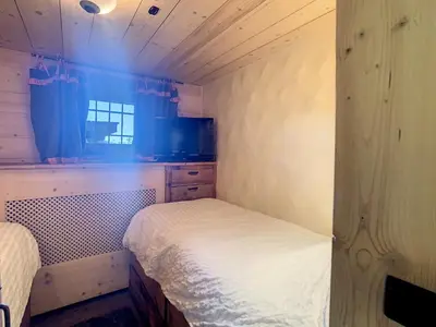 a small bedroom with two beds and a window at Chalet 6 pièces à Combloux avec cheminée et parking - FR-1-560-21 in Combloux
