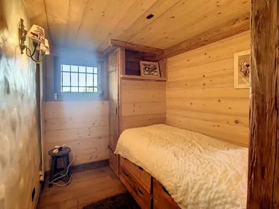 a bedroom in a log cabin with a bed in it at Chalet 6 pièces à Combloux avec cheminée et parking - FR-1-560-21 in Combloux