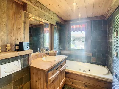 a bathroom with a tub and a sink and a bath tub at Chalet 6 pièces à Combloux avec cheminée et parking - FR-1-560-21 in Combloux