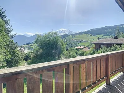 a wooden deck with a view of the mountains at Chalet 6 pièces à Combloux avec cheminée et parking - FR-1-560-21 in Combloux