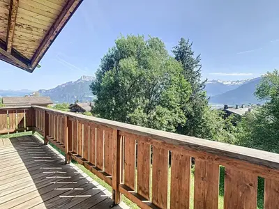 a wooden deck with a view of mountains at Chalet 6 pièces à Combloux avec cheminée et parking - FR-1-560-21 in Combloux